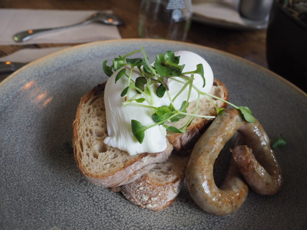 poached egg on toasted sourdough with sausage