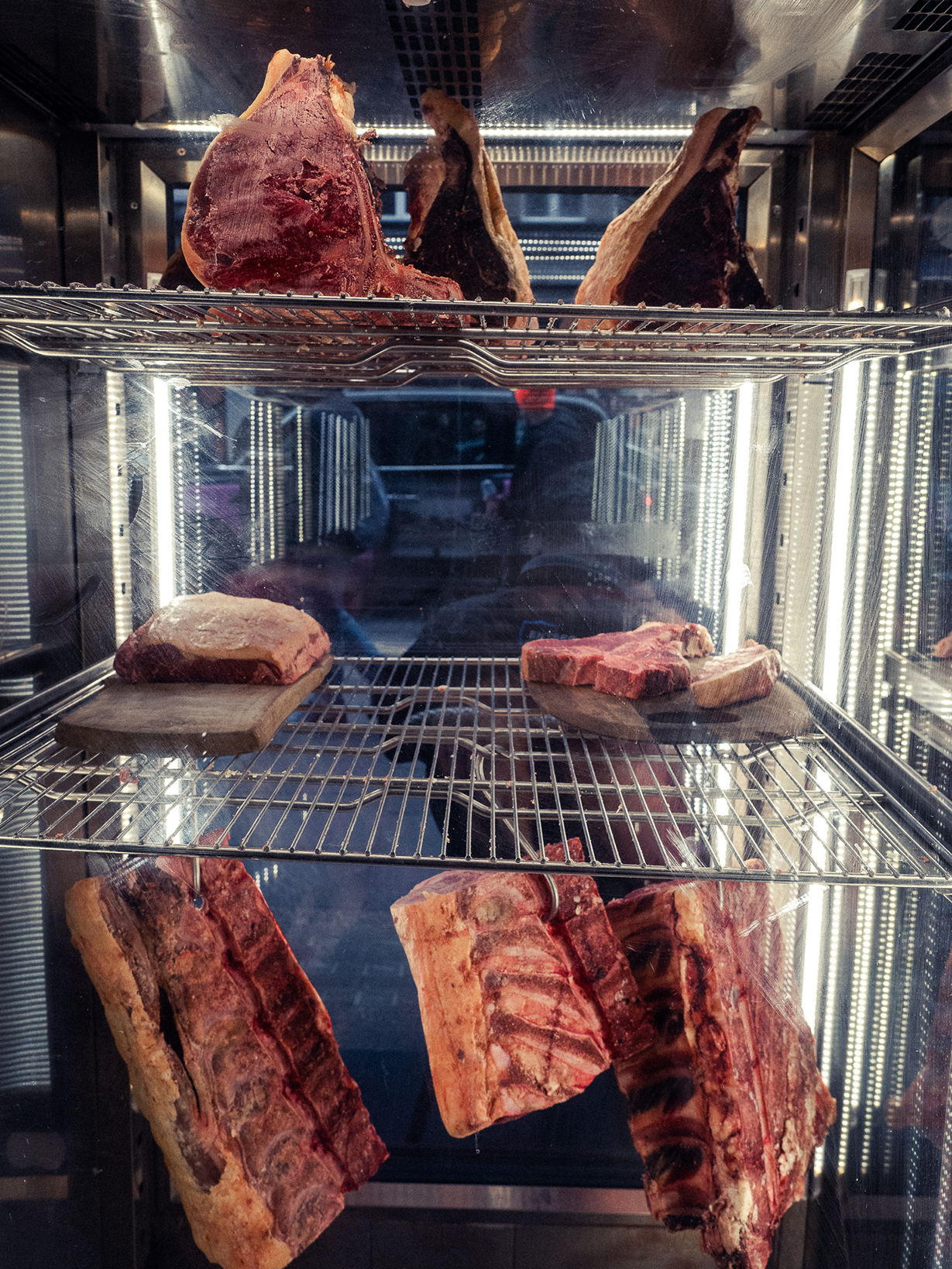 meat hanging on metal clips cabinet