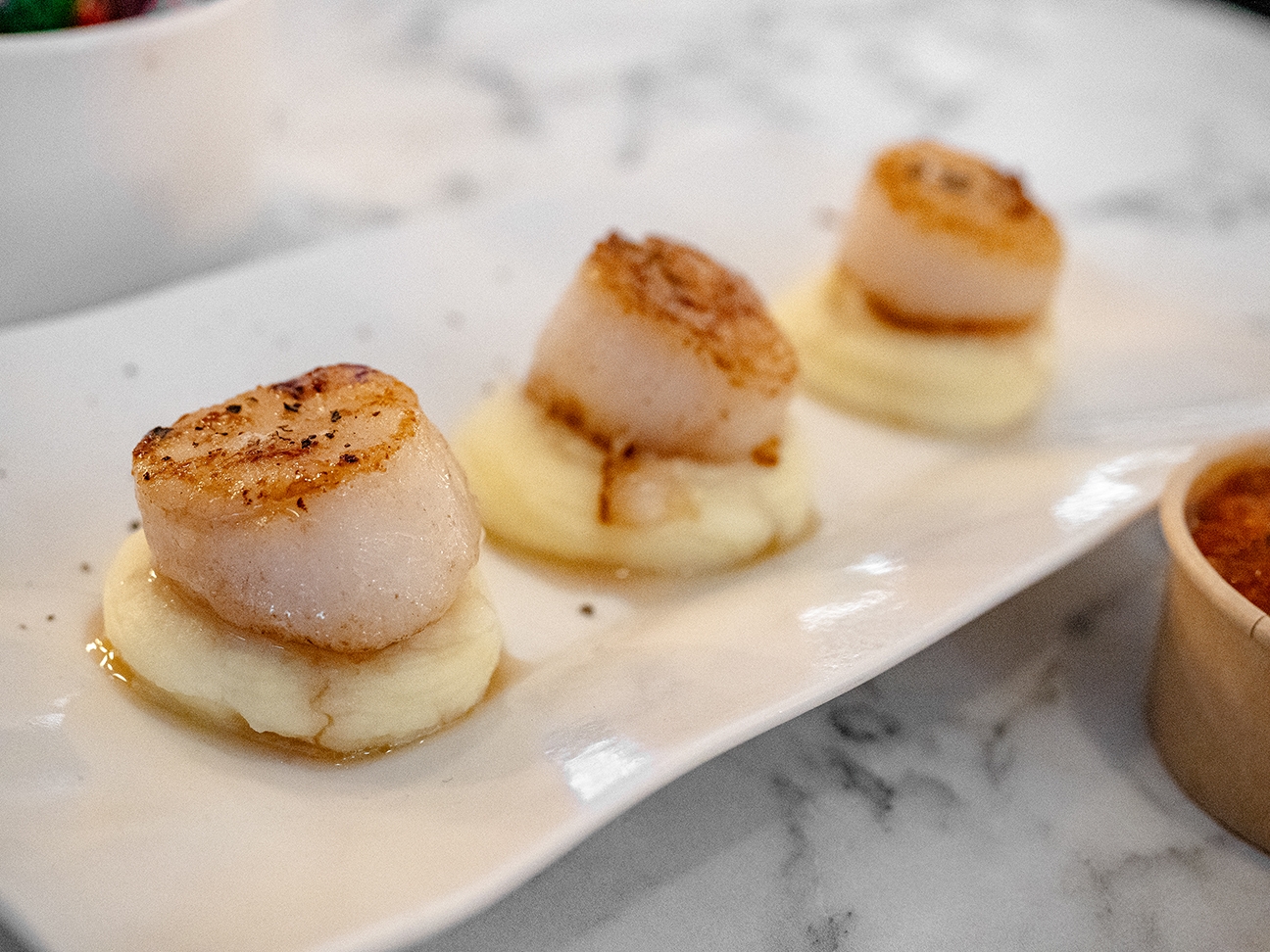 side view of pan seared scallops